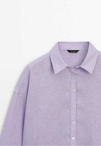 Light lavender linen shirt with a classic collar, long sleeves, and button front. Features a breathable texture and a relaxed fit.