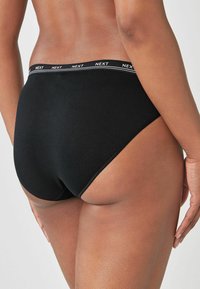 Zwarte katoenen hipster onderbroek met een logo-band en een gladde textuur. Het ontwerp heeft minimale bedekking en een klassieke snit.