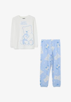 Ensemble de pyjama pour enfants comprenant un haut blanc à manches longues avec un graphique d'ours et le texte "DOUX RÊVES", ainsi qu'un pantalon bleu avec des motifs d'ours.