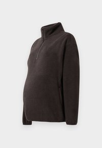 Donkerbruin fleece pullover met een hoge kraag, halve ritssluiting aan de voorkant en zijzakken. Zachte textuur en relaxte pasvorm, geschikt voor zwangerschapskleding.