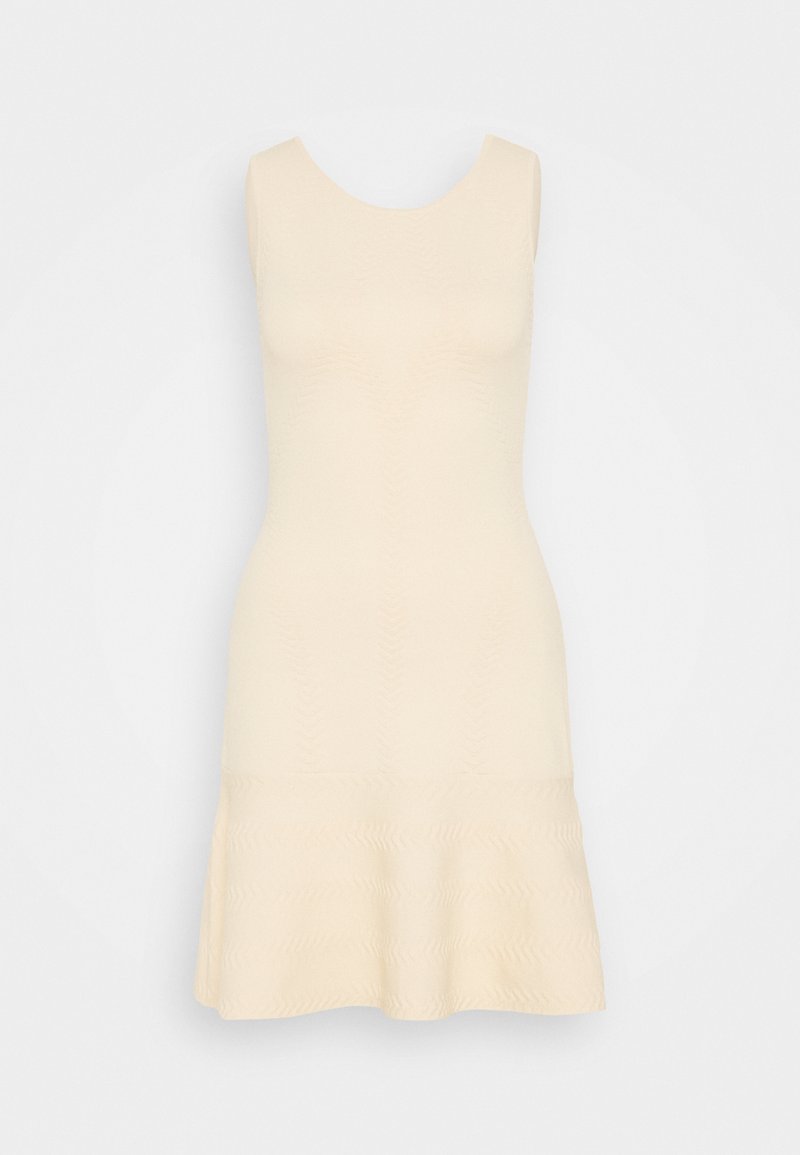 Polvipituisessa, hihattomassa mekossa vaaleanbeige väri. Tasainen pinta, jossa on aaltoileva kuvio helman ympäri ja tiukka yläosa.