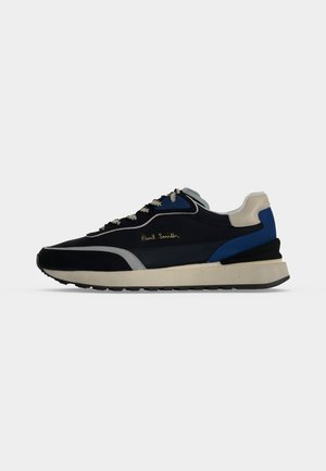 Čiernobielo-modro-sivá teniska s bielou podrážkou a čiernym vzorom, so zlatým logom "Paul Smith" na boku.