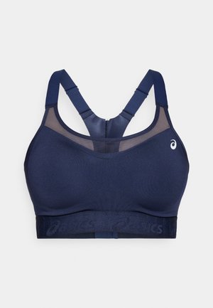 Mornarska športna modrček z mrežastimi detajli, debelimi prilagodljivimi naramnicami in širokim pasom s logotipom blagovne znamke. Gladek, raztegljiv material s podporno zasnovo.