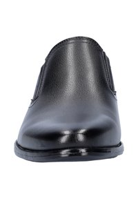 Black leather slip-on shoe featuring a smooth finish, rounded toe, subtle stitching details, and a flat, polished sole.