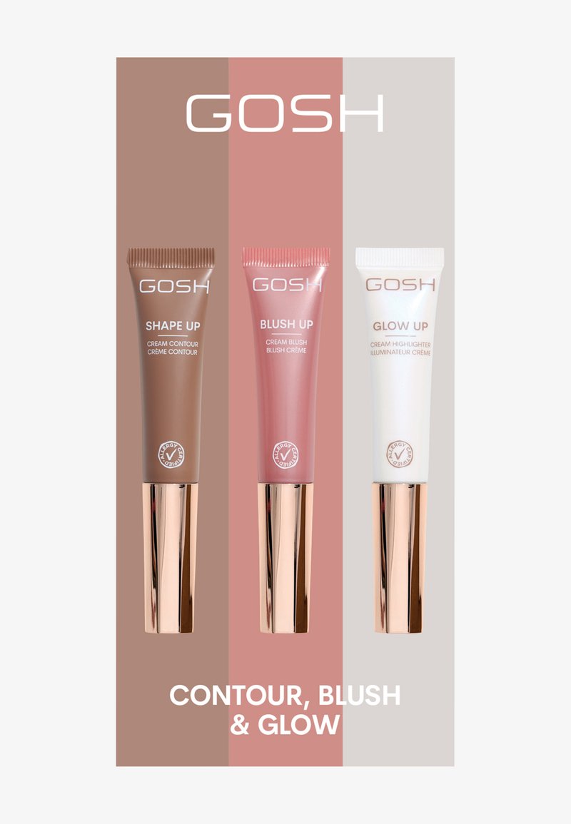 Trzy tubki kremowych produktów kosmetycznych: ciemnobrązowy kontur, różowy róż i biały rozświetlacz, z różowozłotymi zakrętkami i brandingiem.
