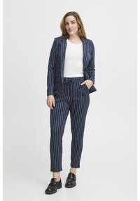 Navy pinstripe blazer and matching trousers made of smooth fabric. The blazer features a notched collar and the trousers have an elastic waist.