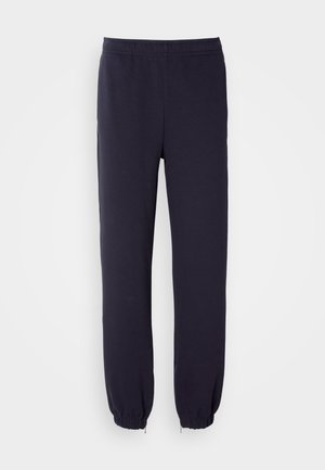 Pantaloni della tuta blu navy con vita elasticizzata e orli regolati. Realizzati in tessuto morbido con una texture liscia, privi di motivi o decorazioni visibili.
