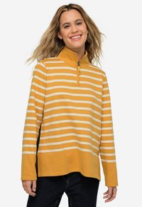 Pullover a righe gialle e bianche con zip a un quarto e colletto alto. Tessuto morbido, maniche lunghe e spacchi laterali per il comfort.