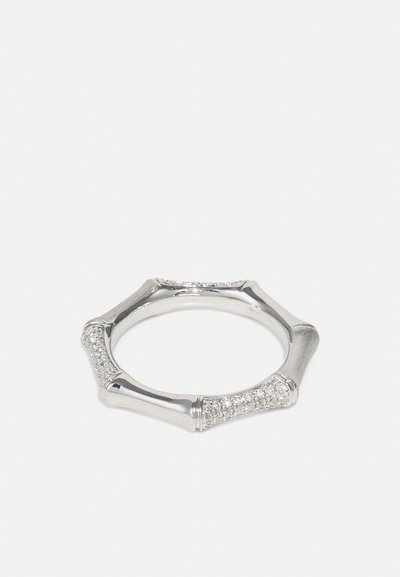 Silver ring with an octagonal shape, featuring smooth and textured sections, accented with small clear gemstones along the band.