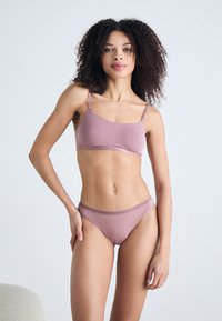 Light mauve bra and matching panties, made from soft fabric. Bra features thin straps and a simple design, with a comfortable waistband on the briefs.