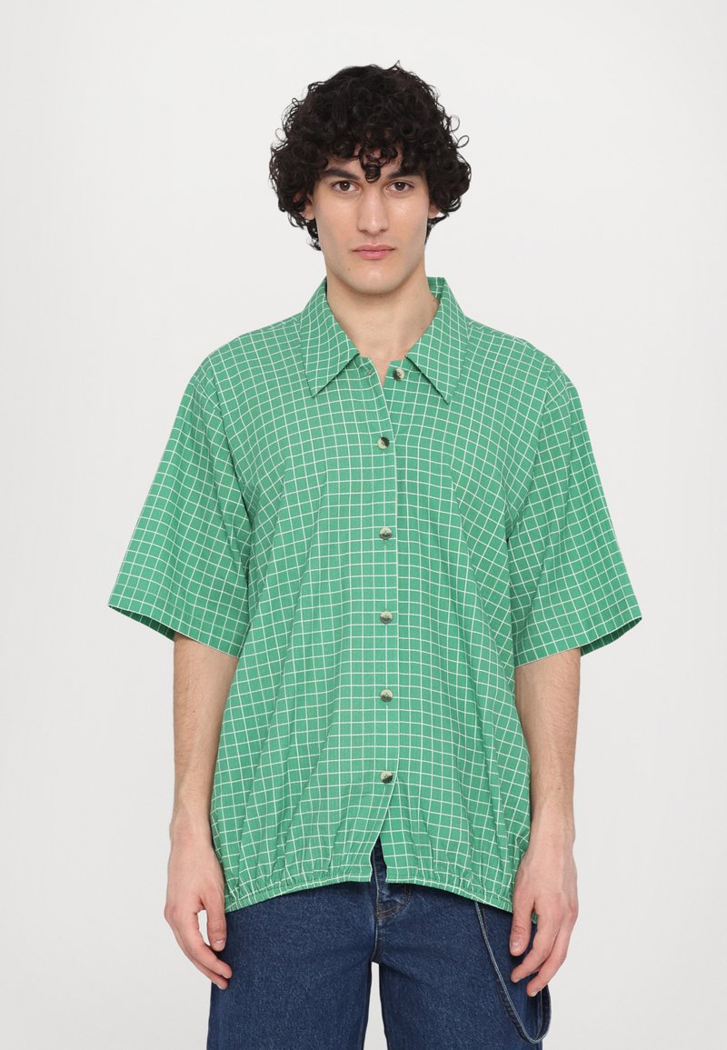 Green short-sleeve shirt with white grid pattern, button front, and elastic hem. Lightweight fabric, collar design, and relaxed fit.