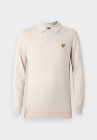 Polo a maniche lunghe beige chiaro realizzato in tessuto morbido, con colletto classico, pattina con tre bottoni e un piccolo logo a forma di farfalla gialla.