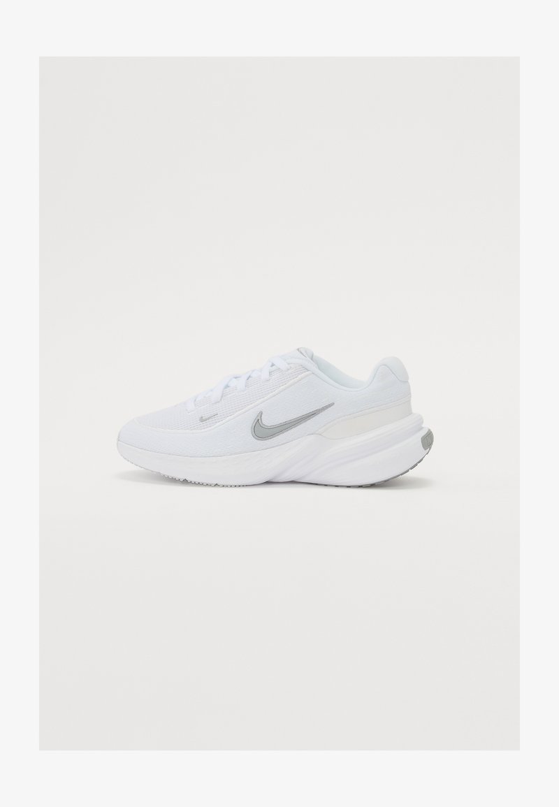 White athletic shoe with mesh upper, gray accents, thick midsole, and textured outsole. Features lace closure and logo on side.