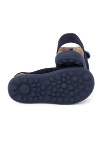 Navy suede sandal with a rubber sole featuring a textured grip, adjustable strap, and a shaped footbed for comfort.