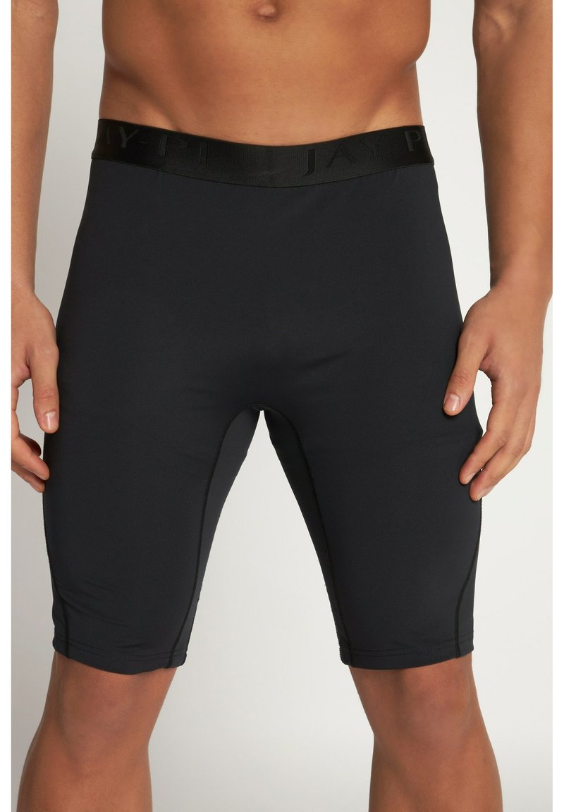 Pantaloni sportivi neri realizzati in materiale elasticizzato e liscio. Presentano una vita testurizzata con logo del marchio e cuciture piatte per il comfort.