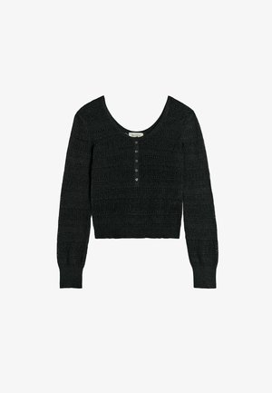 Mustast kudumist pikkade varrukatega lühike kardigan ümara kaelusega, esikinnis nööpidega ning soonikkoes varrukaservade ja äärega.