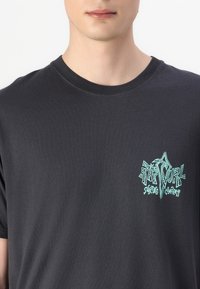Schwarzes Baumwoll-T-Shirt mit kurzen Ärmeln, mit einem türkisfarbenen Grafikdruck auf der linken Brust eines Surf-Unternehmenslogos.