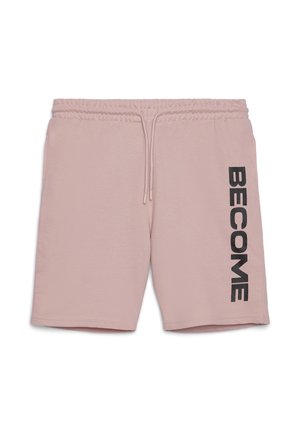 Shorts rosa chiaro in tessuto morbido, con vita regolabile con coulisse e testo nero in grassetto "BECOME" sul lato sinistro.