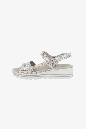 Floral-patterned wedge sandals with white base, adjustable straps, textured insole, and cushioning for comfort. Side view displayed.