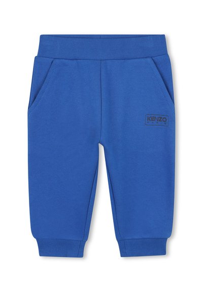 Pantalons de survêtement bleus en tissu doux, présentant une taille élastique côtelée, deux poches latérales et un discret patch logo "KENZO" noir.