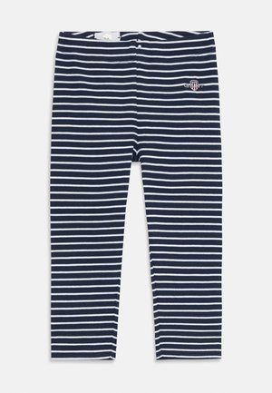 Leggins rayés bleu marine et blancs en tissu mélangé coton, présentant une coupe ajustée et un petit logo brodé près de la taille.