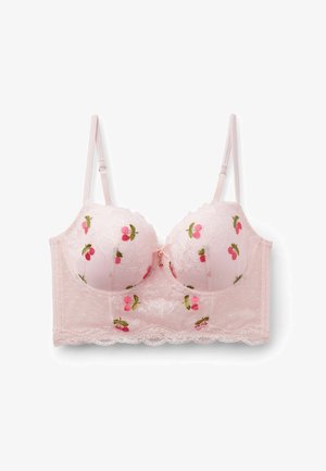 Jasnoróżowy koronkowy biustonosz z haftem wiśni, regulowanymi ramiączkami i falbanką z koronki na dolnym pasku.