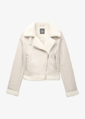Jachetă bej deschis căptușită cu blană artificială, cu design scurt, reveruri late, fermoar asimetric și două buzunare laterale cu fermoar. Exterior cu textură.