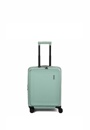 Compacte mintgroene harde koffer met uitgeschoven zwarte telescoopgreep en vier zwarte zwenkwielen.