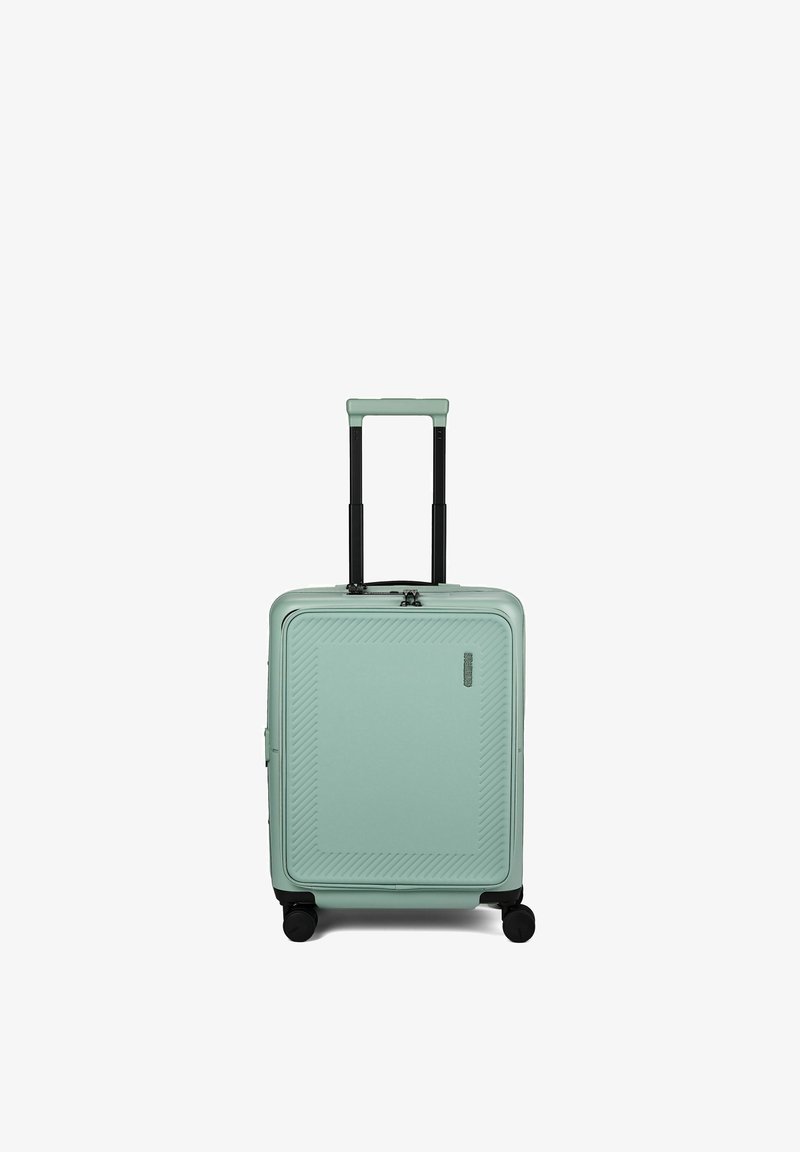Valise rigide compacte vert menthe avec poignée télescopique noire étendue et quatre roues noires multidirectionnelles.