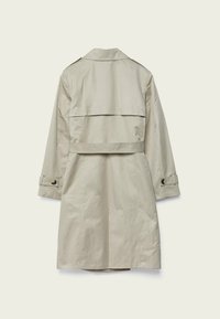 Trench-coat beige clair à manches longues, taille ceinturée, empiècement au dos et poignets à boutons, avec une texture lisse et légèrement brillante.