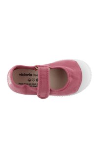 Zapato Mary Jane de lona rosa con punta y suela de goma blanca, con una tira de velcro y texto de la marca visible en el interior.