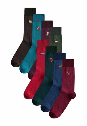 Bunte Socken in acht Farbtönen, darunter Braun, Türkis, Kastanienbraun, Rot, Dunkelgrün und Blau, mit kleinen gestickten Tiermotiven.