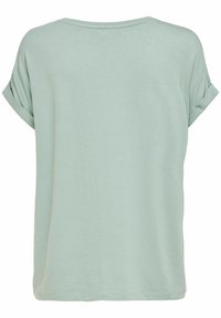 T-shirt vert menthe à manches courtes avec une coupe décontractée. Design simple, texture douce et manches roulées. Encolure propre et ourlet droit.
