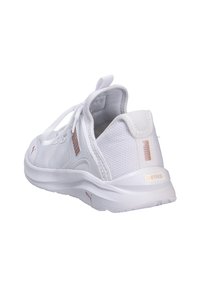 White athletic shoes with a textured mesh upper, a padded collar, soft sole, and subtle rose gold accents. Features a lace-up design.