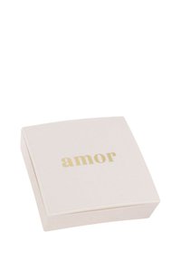 Pequeña caja de joyería cuadrada color beige con lettering dorado "amor" en la tapa, sobre un fondo blanco.