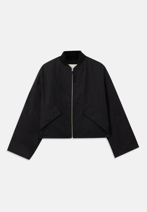 Black bomber jacket with a zip front, cropped design, and two angular pockets. Made from smooth fabric with a ribbed collar and wide sleeves.