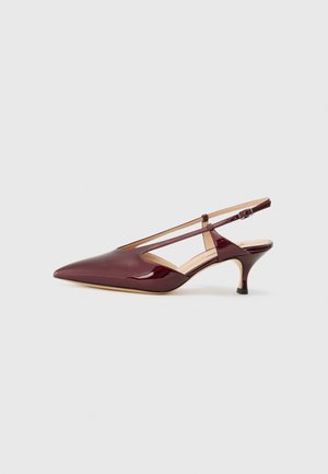 Burgundy patent leather slingback shoe with a pointed toe and a thin heel. Features a strap with a buckle and cut-out side design.