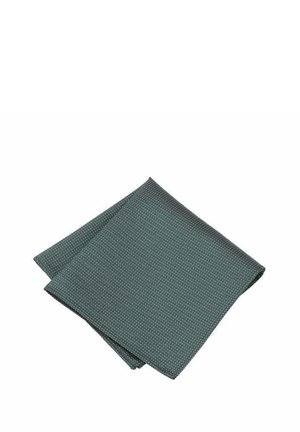 Green patterned napkin made of fabric, featuring a subtle white dot design, folded into a square shape with a smooth texture.