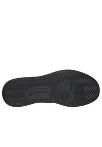 Suola di scarpa in gomma nera con un motivo testurizzato, caratterizzato da elementi circolari e zigzag. Il logo "SKECHERS" è stampato in rilievo sul lato.