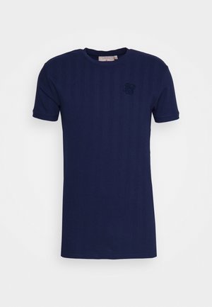 Camiseta azul marino hecha de tejido texturizado, con cuello redondo y mangas cortas. Incluye un pequeño logotipo en relieve en el pecho.