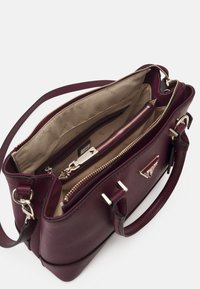 Deep burgundy handbag with a textured exterior. Features gold-tone hardware and dual top handles. Interior includes multiple compartments and zippered pocket.