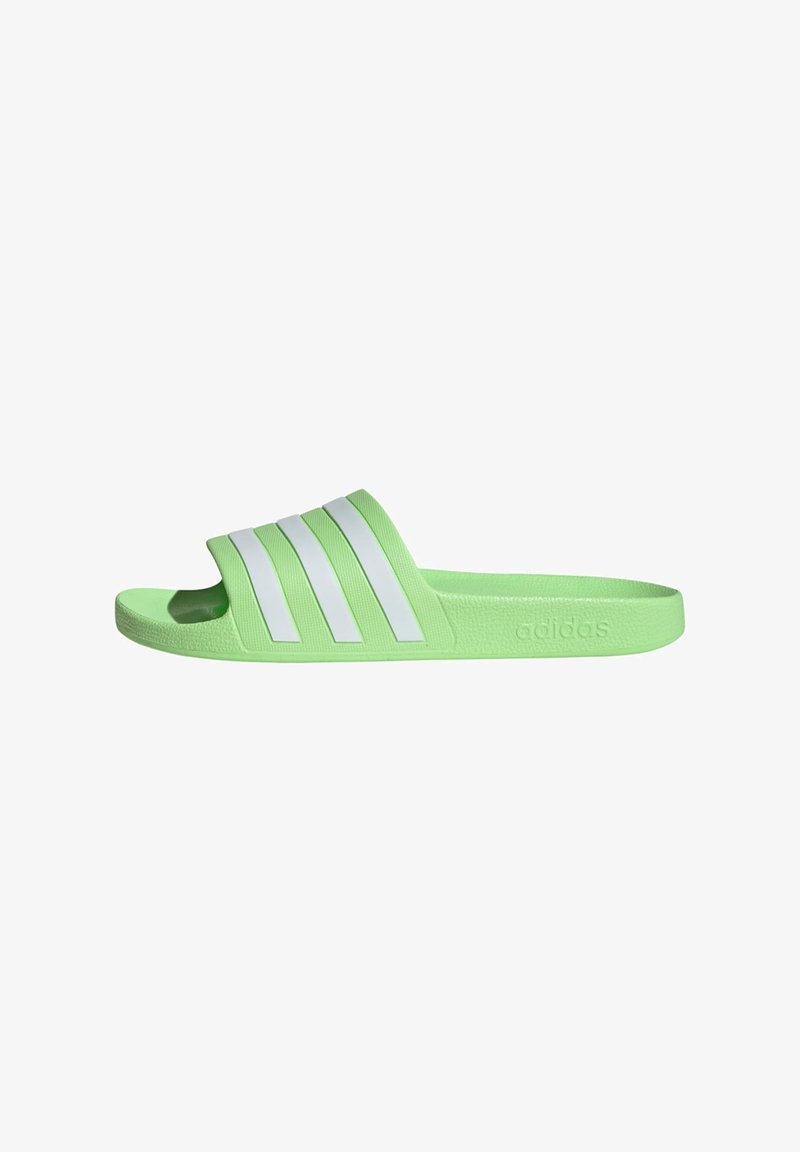 Green slide sandal featuring three white stripes on the upper. Textured footbed and strap, with embossed logo on the side. Lightweight design.