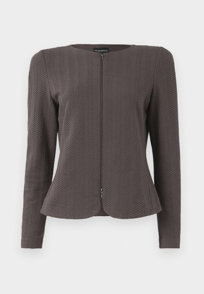 Brown textured blazer with a round neckline and front zipper. Features a chevron pattern and long sleeves, tailored fit.