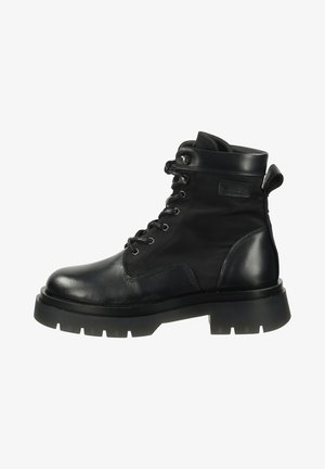 Black lace-up ankle boot with rugged sole, padded collar, and pull tab on the back, featuring mixed leather and fabric materials.