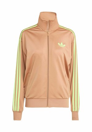 Beige zipzáras edződzseki magas gallérral, neon zöld háromcsíkos díszítéssel a hónalj részen és egy kis logóval a mellrészen.