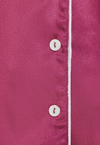 Fuchsia satijnen overhemd met een knoopsluiting met een witte accent, zachte textuur en subtiele glans. De knopen zijn rond met een draaddetail.