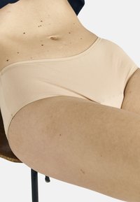 Light beige cotton-blend hipster underwear with a smooth texture, featuring a wide waistband and minimal seams for comfort.