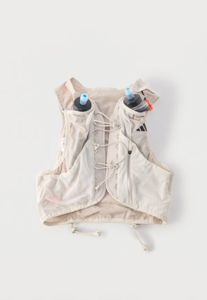 Hele beež värviga jooksuvest reguleeritavate eesmistest nööridest, kahe esitaskuga joogipudelite jaoks, mis hoiavad siniste suulülidega pudelid, ja eesmine tõmblukuga tasku.