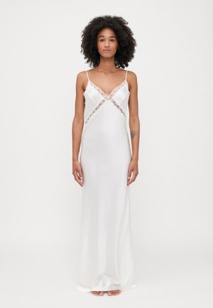 Silk nightgown in white with lace trim along the neckline and sides, featuring thin spaghetti straps and a flowing, straight silhouette.