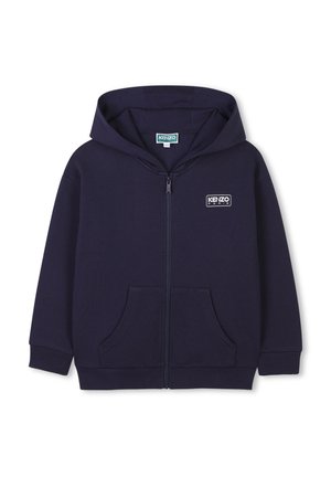 Navy blue zip-up hoodie with a kangaroo pocket, ribbed cuffs, and a logo patch on the left chest; made from textured cotton material.